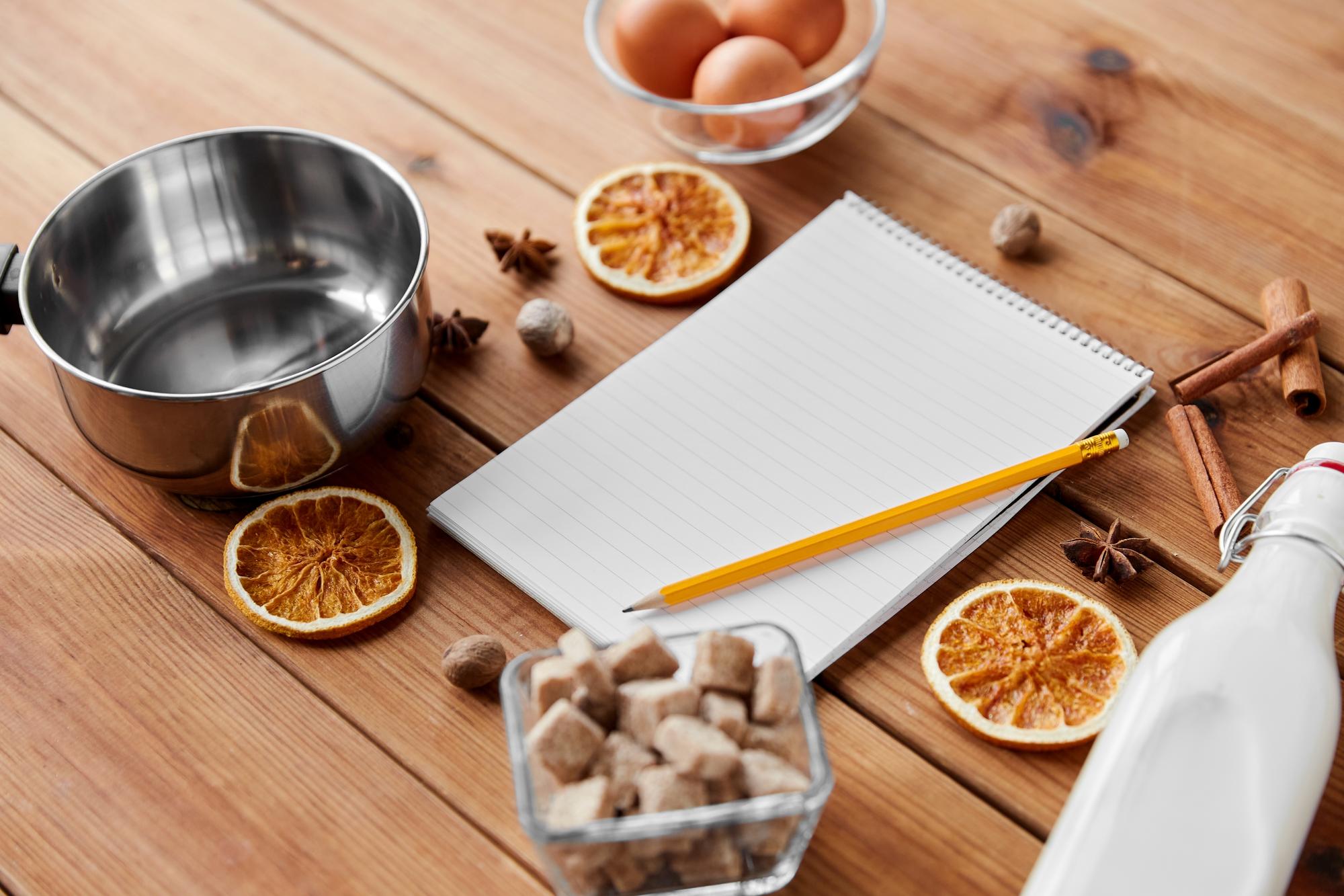 Personal kitchen workspace with cooking tools and recipe notes
