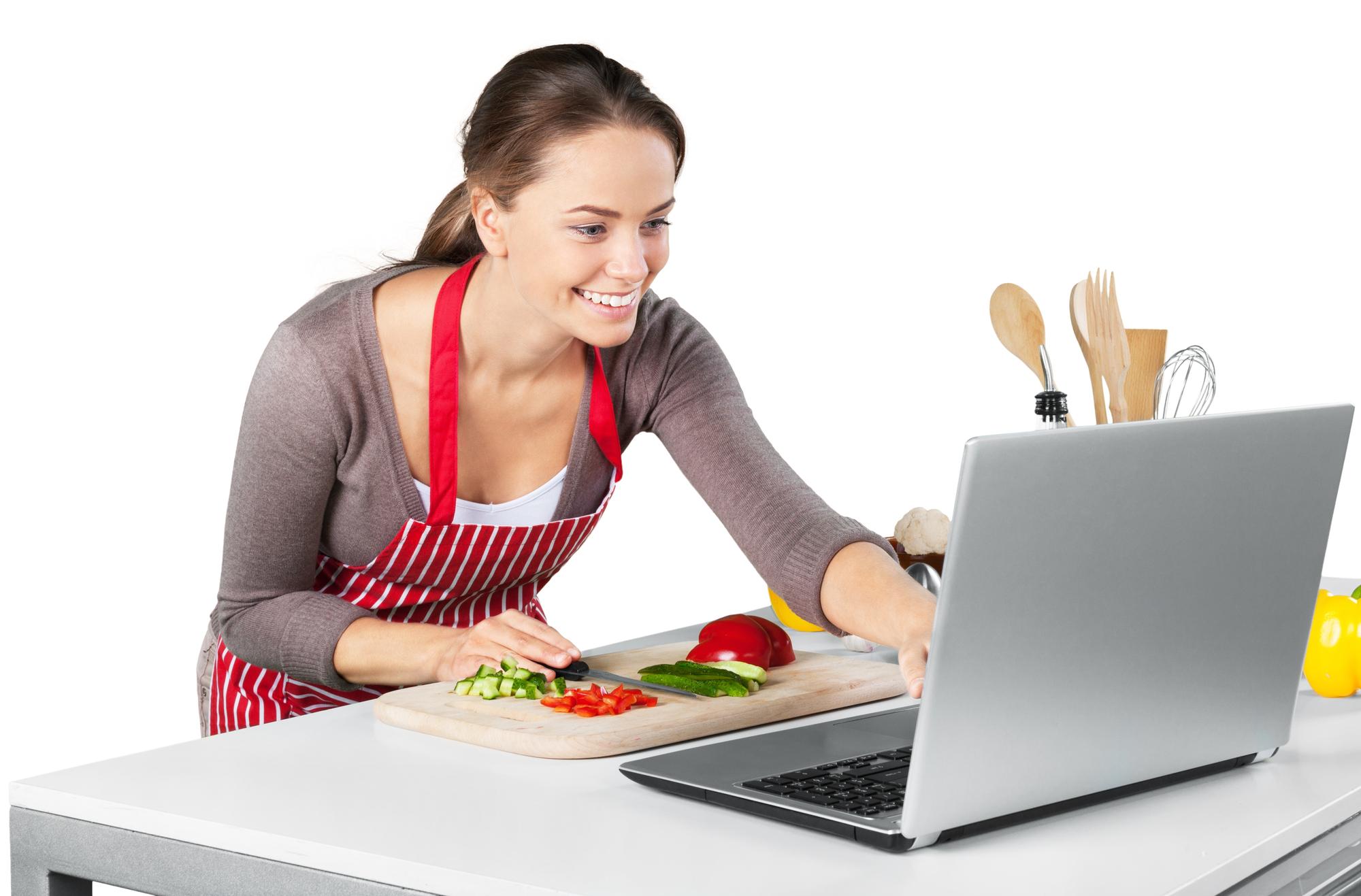 Student chopping vegetables in a bright kitchen